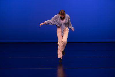 A Teen Performance Company dancer tap dancing on a stage.