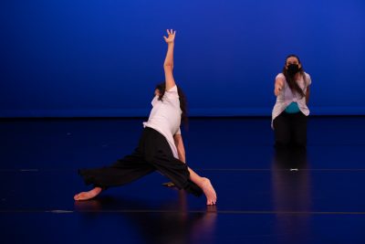 Two Adult Performance Company dancers performing on stage.