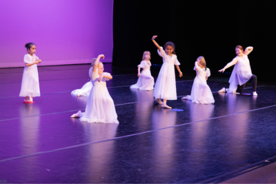 5 young dancers in long white dresses perform a ballet dance during Dance Project's Spring Showcase.