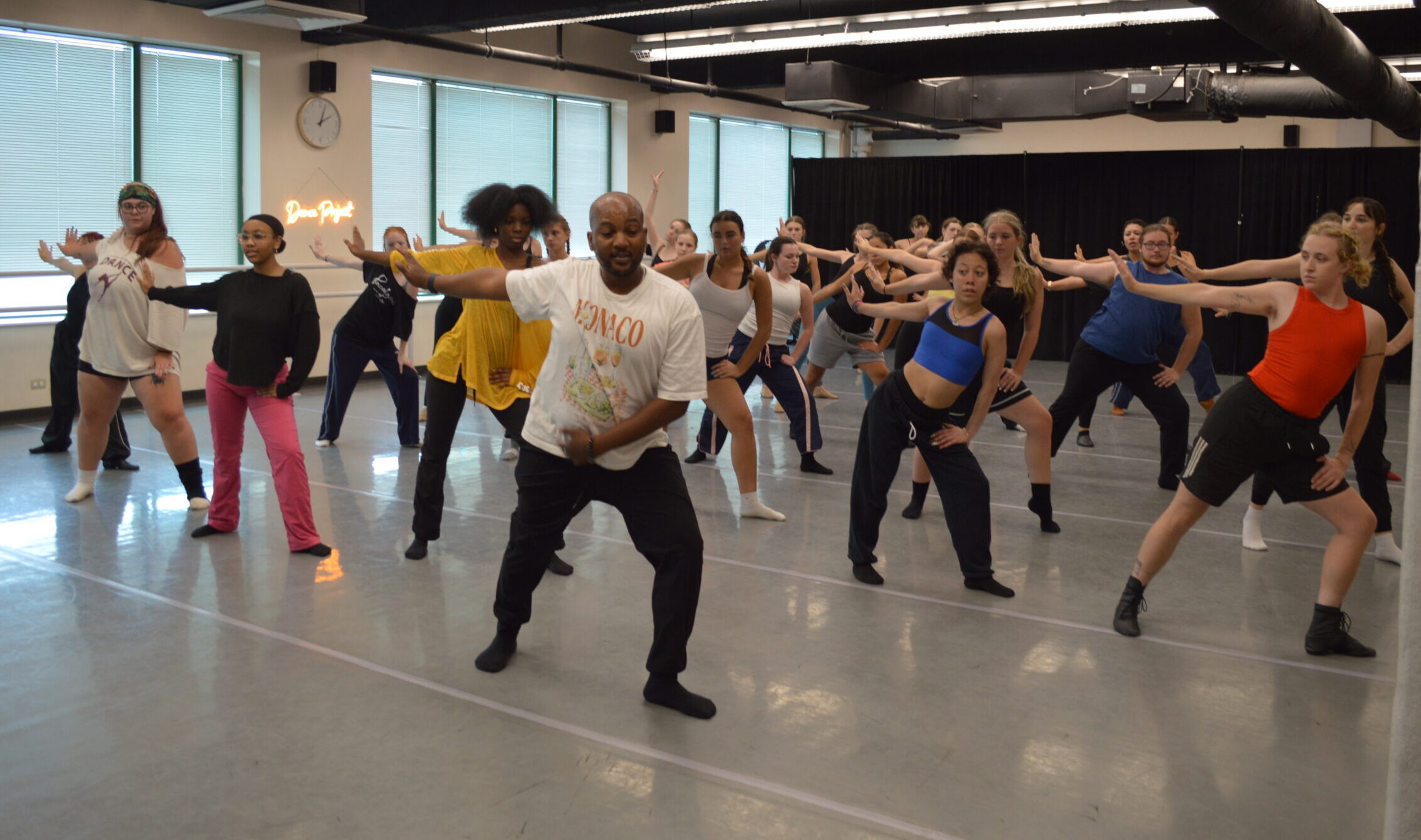 Instructor Maurice Watson leads a full dance studio in a contemporary jazz class during Dance Project's Pre/Pro intensive