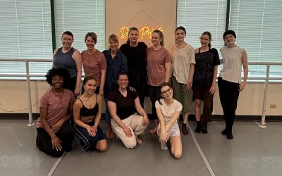 A group of about 13 dancers pose for a picture after a dance class taught by Virginia Dupont.
