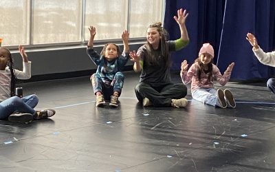 Instructor Kate leads first graders in dance exercises at Peck Elementary.
