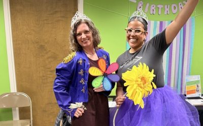 Two women strike a silly pose to show their excitement for Dance Project's parent committee